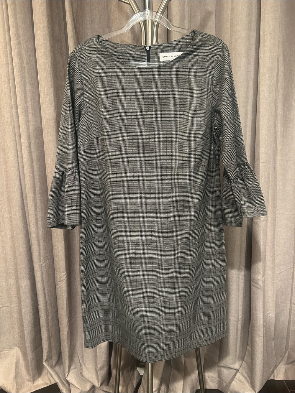 Emma & Michelle Gray Plaid Shift Dress with Ruffle Sleeves has a slight shine.